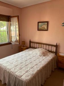 a bedroom with a large bed with a white bedspread at La Casita in Ciudad Quesada