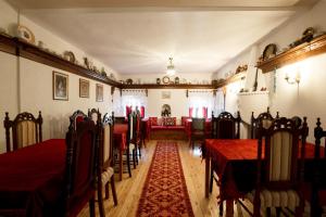 a dining room with red tables and chairs at Boutique Hotel Musée in Gjirokastër