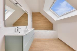 a bathroom with a sink and a mirror and a tub at 450m de la plage, grande maison pour 10 in Saint-Philibert +29 photos