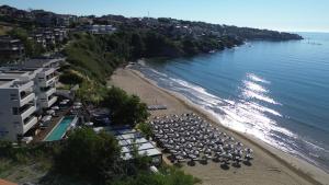 an aerial view of a beach with umbrellas at Olive Villas Beach Hotel in Sozopol