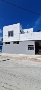 a white building on the side of a street at Cancun calle 28 pte in Cancún