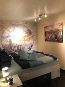a bedroom with a large bed with a large window at Ferienappartement Marburg Giessen in Hachborn