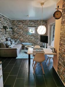 a living room with a couch and a table at Ferienappartement Marburg Giessen in Hachborn