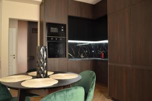 a kitchen with a table and chairs in a room at Park Gate apartment in Chernivtsi