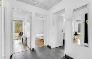 a hallway with a mirror and a bedroom at Holiday Home Dyrefolden Ringkøbing Ii in Ringkøbing