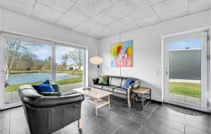 a living room with two couches and a table at Holiday Home Dyrefolden Ringkøbing Ii in Ringkøbing +13 photos