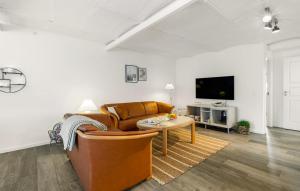 a living room with a couch and a table at Broagerland ferielejlighed Sønderborg Gråsten in Broager