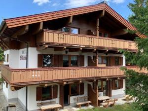a large house with wooden balconies on it at Haus Wildkarblick Top 4 in Königsleiten +25 photos