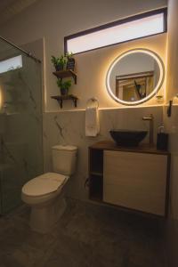 a bathroom with a toilet and a sink and a mirror at Naiot Hotel Boutique in Medellín