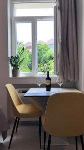 a table with two glasses of wine and a window at Apartment Dora 1 , on the beach in Tivat