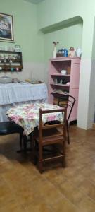 a room with a table and a table and a chair at Pousada Elshaday l in Osvaldo Cruz