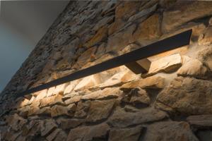 a stone wall with a light on it at L'Authentique Raffiné in Saint-Hubert