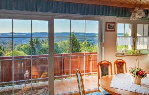 a dining room with a table and a large window at 3 Bedroom Lovely Home In Schnett in Schnett