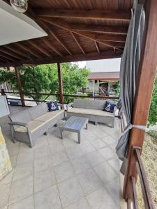 a patio with two couches and a table and a table at Kuşadası Davutlar'da Huzur Rahat ve Konfor Bir Arada in Aydın +17 photos