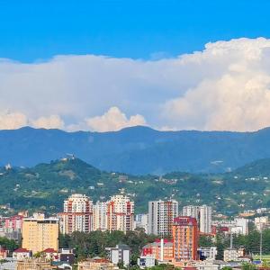 a city with buildings and mountains in the background at Seaside 2-Room 3-Balconies Apt#12 Stunning View in Batumi