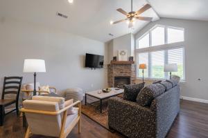 a living room with a couch and a fireplace at Luxury 3BR, 3BA - Vaulted Ceilings - Resort Amenities - Stairs Required - FREE TICKETS INCLUDED - FH-G303 in Branson