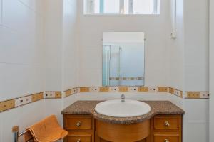 a bathroom with a sink and a mirror at Mercy House - BY Y Concept in Setúbal
