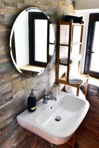 a bathroom with a white sink and a mirror at Torre antica suite in Campagnano di Roma +35 photos