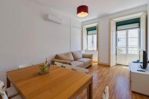 a living room with a table and a couch at Mercy House - BY Y Concept in Setúbal