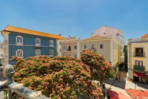 a view of a city with buildings and flowers at Mercy House - BY Y Concept in Setúbal