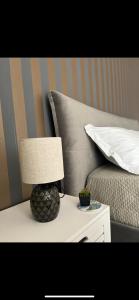 a lamp on a table next to a bed at Labanca's Comfort in Matera