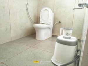 a bathroom with a toilet in a shower stall at Valley Vista Villa Madikeri Coorg in Madikeri