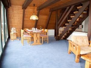 a dining room with a table and chairs at Ferienhaus in Fedderwardersiel mit Terrasse und Garten in Butjadingen