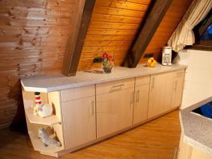 a kitchen with a counter top in a room at Ferienhaus in Fedderwardersiel mit Terrasse und Garten in Butjadingen +14 photos