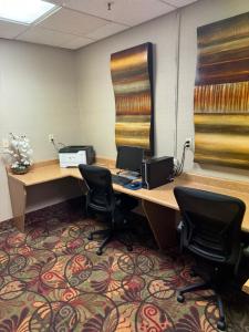 an office with a desk with a laptop and two chairs at Comfort Inn Huntington near University area in Huntington +37 photos