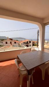 a table and chairs on a balcony with a view at Villa Dei Tigrotti in Santa Maria di Castellabate