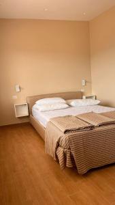 a bedroom with a large bed with white sheets at Villa Dei Tigrotti in Santa Maria di Castellabate +21 photos