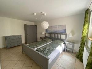 a bedroom with a bed and a chandelier at Ferienwohnung FeNiMo in Elzach