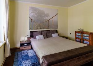 a bedroom with a bed with a bridge painting on the wall at Gemütliches Ferienhaus mit großem Balkon in Ahrensbök +14 photos