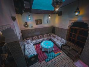 a living room with a couch and a table at Dar El Mizan Entier place in Fès +5 photos
