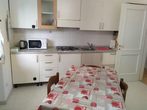 a kitchen with a table with a table cloth on it at easy home Lake in Arona