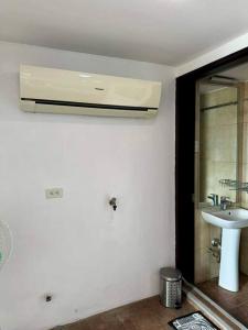 a white bathroom with a sink and a mirror at Relaxing Loft Unit in Cebu City in Cebu City +15 photos