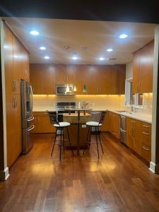 a kitchen with wooden cabinets and a island with bar stools at The Lodge at Stony Point in Jay