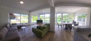 a living room with a green couch and a table at Meem in Konjic +7 photos
