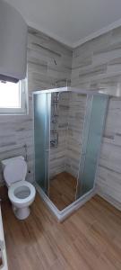 a bathroom with a toilet and a glass shower at Meem in Konjic