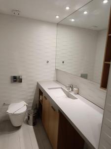 a bathroom with a toilet and a sink and a mirror at Sandy Suite 3 in Agia Marina Nea Kydonias +13 photos