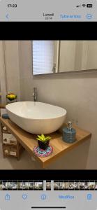 a bathroom with a large white sink and a mirror at Labanca's Comfort in Matera