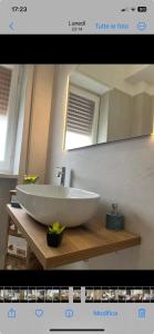a bathroom with a white sink and a mirror at Labanca's Comfort in Matera +13 photos
