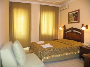 a hotel room with a bed and a couch at Hotel Bağevleri in Gümbet +26 photos