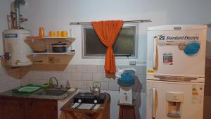 a kitchen with a refrigerator and a sink at Departamento familiar in Gualeguaychú +1 photo