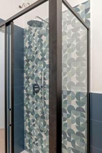 a bathroom with a shower with a glass door at 5 minuti dal porto CityAndSea in Livorno +18 photos