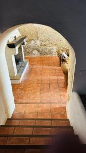 a room with a stone archway with a bench at Holiday Home Finca Binimazoch in Punta Grossa