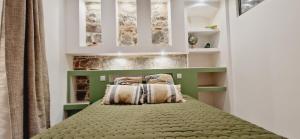 a bedroom with a bed with two pillows on it at Appartement plein de charme - Ajaccio hyper centre in Ajaccio