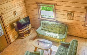 a living room with a couch and a table and a television at 2 Bedroom Nice Home In Mscice in Mścice