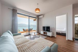 a living room with a couch and a view of the ocean at Casa Mare in Vlorë