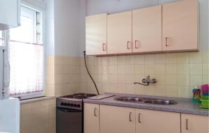 a kitchen with a sink and a stove at Apartment Lumbarda Iv in Lumbarda